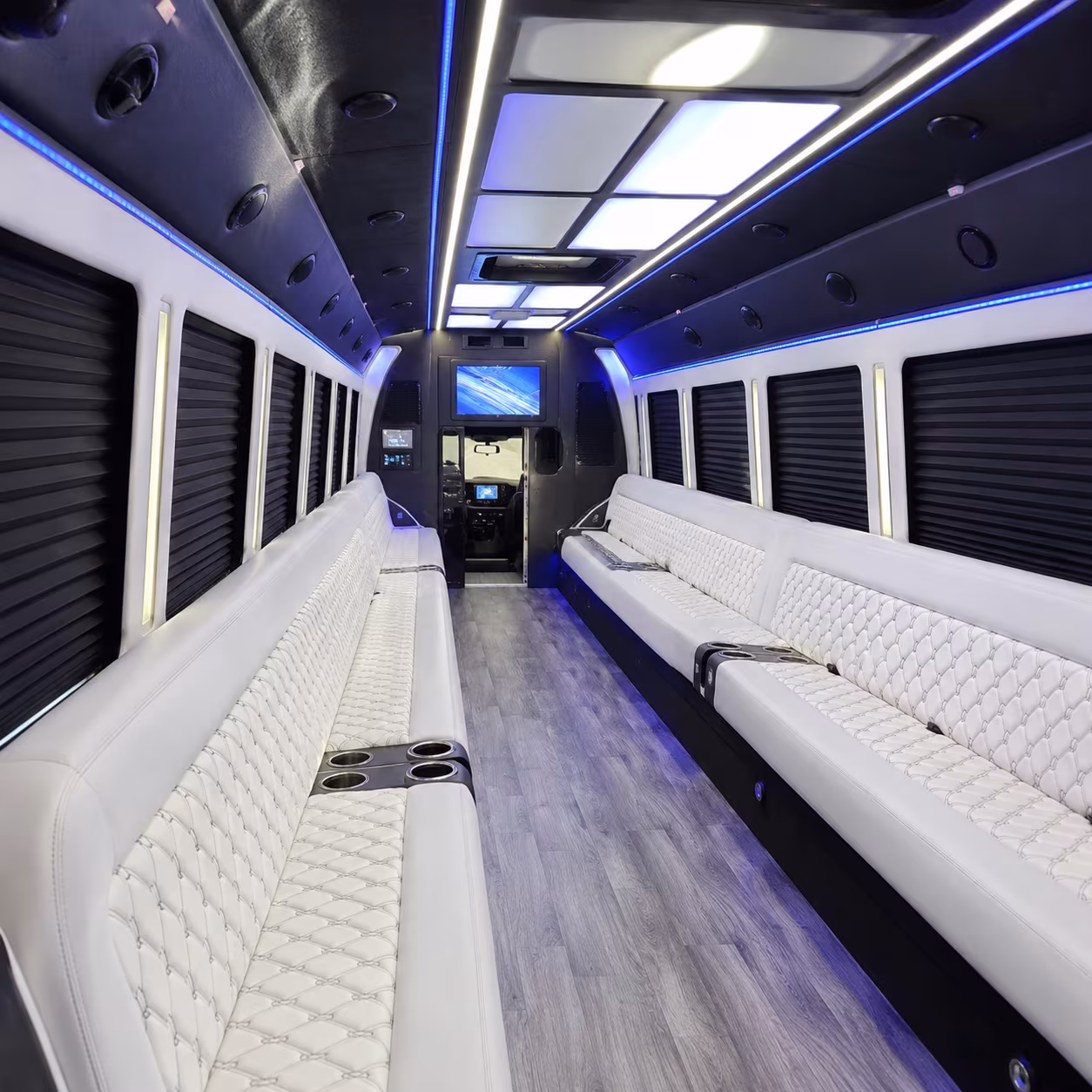 Friends laughing during a party bus celebration in Grand Rapids