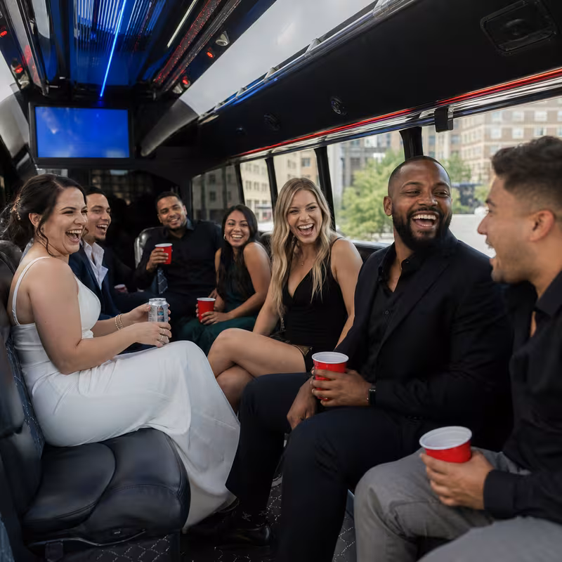 Party bus interior with wraparound leather seating and LED lighting in Grand Rapids