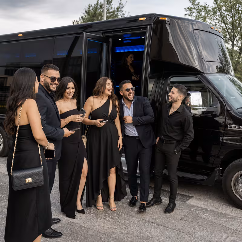 Passengers loading luggage while boarding an Grand Rapids group shuttle