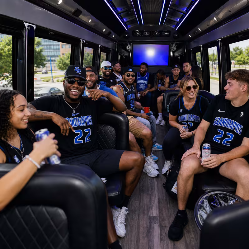 Group boarding a white charter bus for Sporting Event Transportation transportation in Grand Rapids