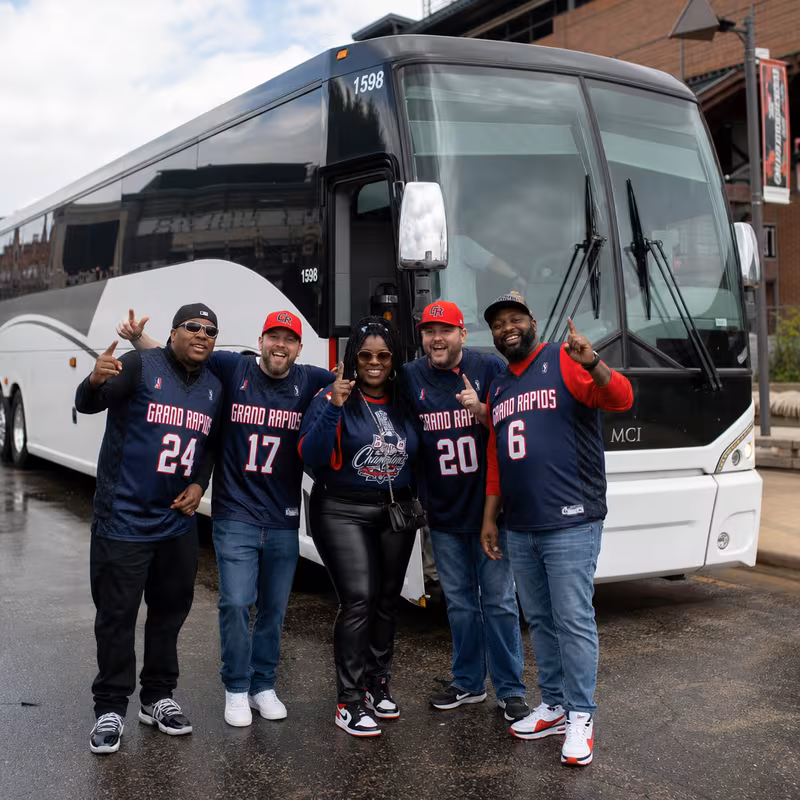 Passengers loading luggage while boarding an Grand Rapids group shuttle