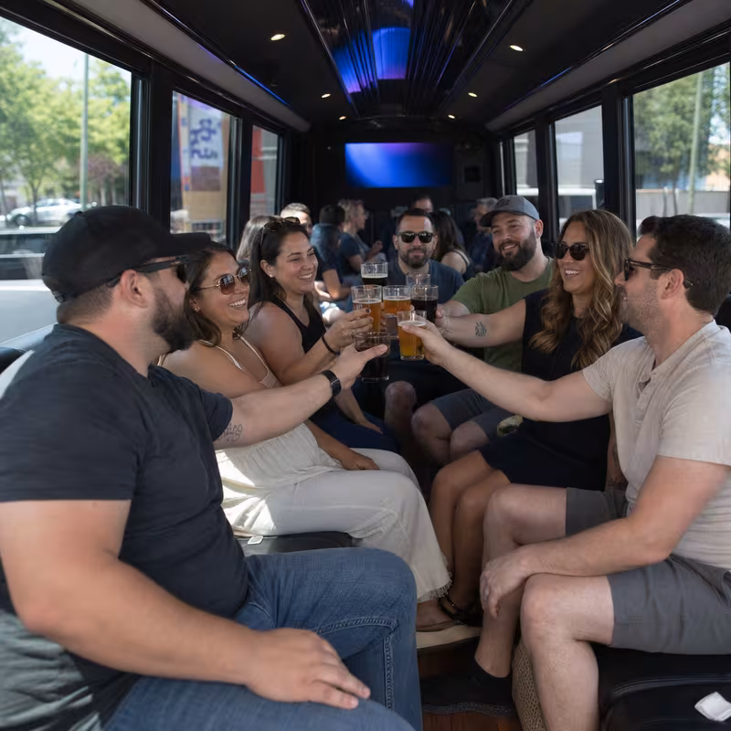 Group boarding a white charter bus for Winery & Brewery Tour Transportation transportation in Grand Rapids